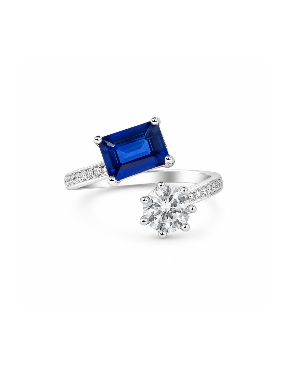 Silver ring with a blue gemstone and diamond on a white background