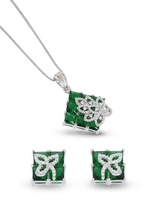 Jewelry set with emerald green gemstones and silver accents on a white background