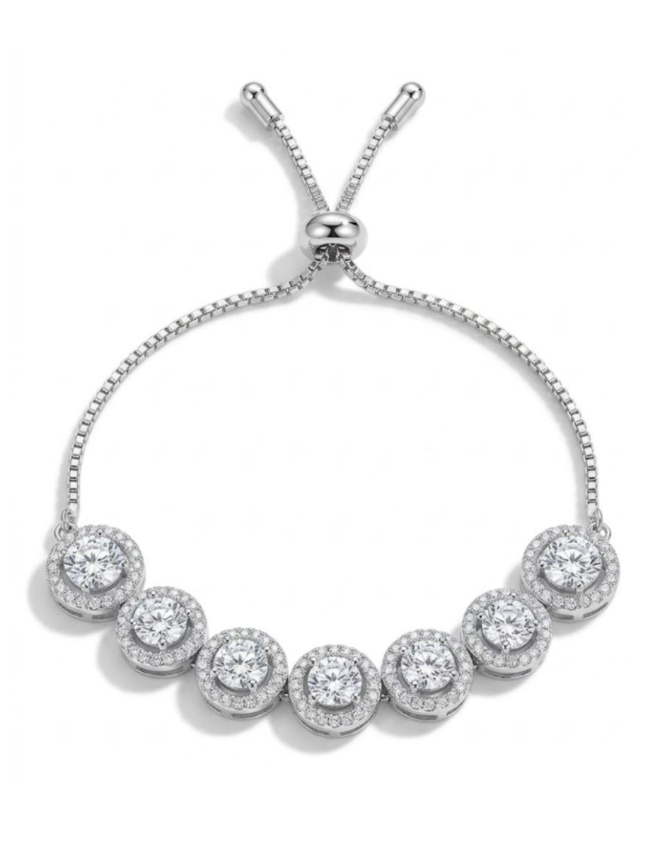 Silver bracelet with round gemstones on a white background