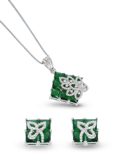 Jewelry set with emerald green gemstones and silver accents on a white background