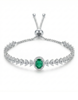 Silver bracelet with a green gemstone on a white background